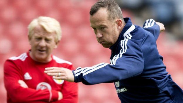 Scotland manager Gordon Strachan keeps an eye on Charlie Adam