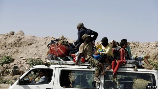 People flee an area of Yemen's capital, Sanaa, targeted by Saudi-led coalition aircraft (12 May 2015)
