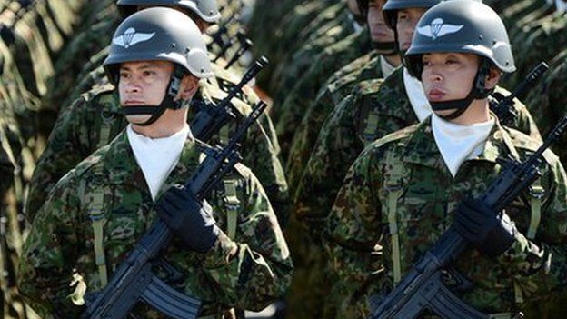 Japanese soldiers listen to Prime Minister Shinzo Abe during the military review at the Ground Self-Defence Force's Asaka training ground on October 27, 2013.