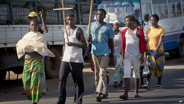 Residents of Bujumbura carry a cross to show impartiality, 14 May