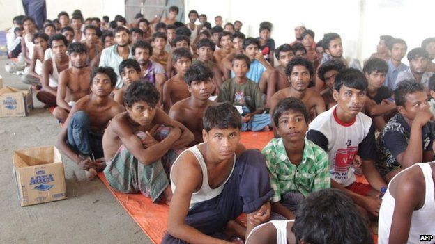 A group of rescued migrants mostly Rohingya from Myanmar and Bangladesh gathered on arrival at the new confinement area in the fishing town of Kuala Langsa in Aceh province on May 15, 2015.