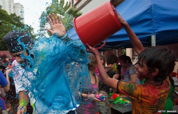 A man is splashed with blue paint