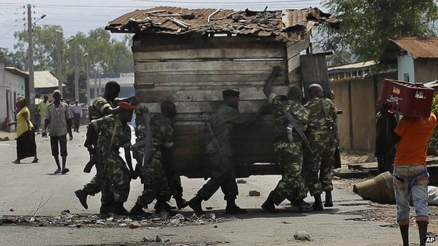 Troops remove a barricade in the capital Bujumbura. 16 May 2015