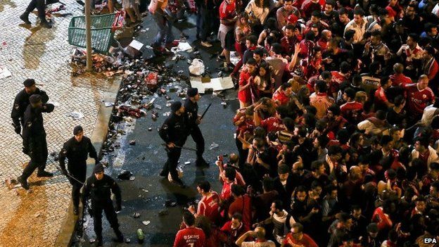 Benfica soccer fans clash with police during celebrations at the Marques de Pombal Square in Lisbon, Portugal on 17 May 2015.