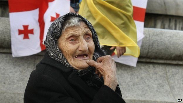An elderly woman watches an opposition rally in Tbilisi