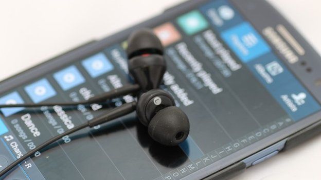 A Samsung mobile phone with headphones