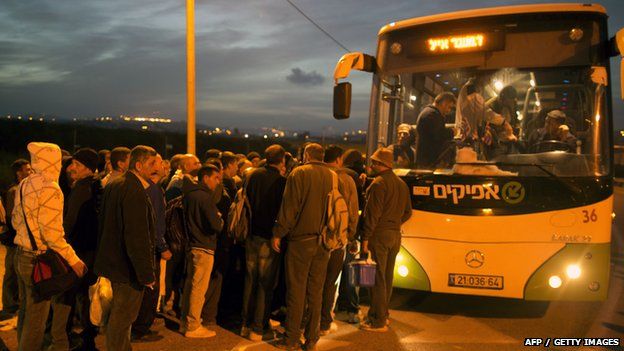 Palestinians queue to board a bus as a new line is made available by Israel to take Palestinian labourers from the Israeli army crossing Eyal, near the West Bank town of Qalqilya, into the Israeli city Tel Aviv, 4 March 2013