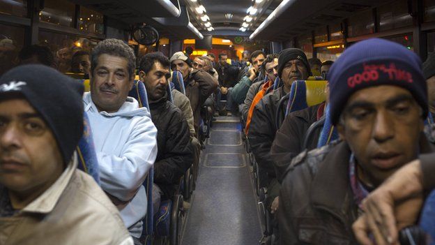 Palestinians sit in a bus as a new line is made available by Israel to take Palestinian labourers from the Israeli army crossing Eyal, near the West Bank town of Qalqilya, into the Israeli city Tel Aviv, 4 March 2013