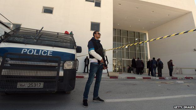 Tunisian security forces and forensic experts stand at the visitors entrance of the National Bardo Museum in Tunis