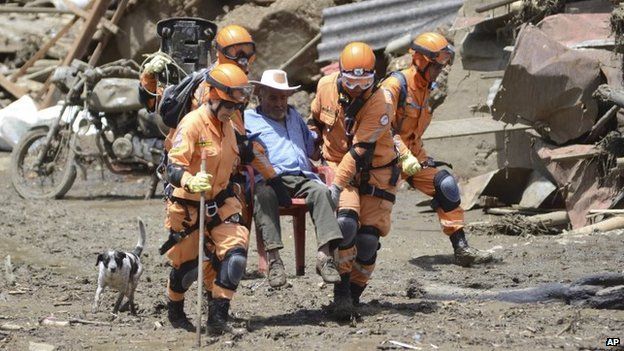 Rescue workers help a victim of an avalanche in Salgar on 19 May, 2015.