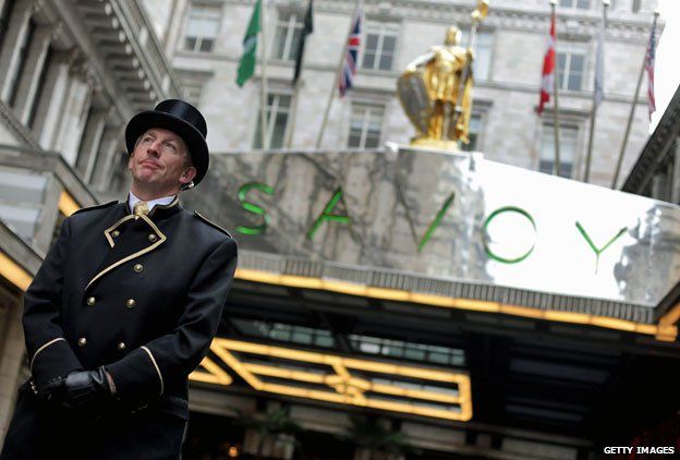 A doorman stands outside the Savoy hotel