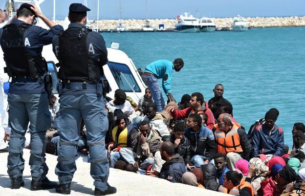 Migrants are helped ashore in Sicily (19 May)