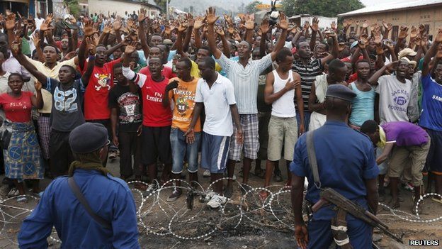 Policemen stand in front of demonstrators during a protest against Burundi President Pierre Nkurunziza and his bid for a third term in Bujumbura, Burundi, May 20