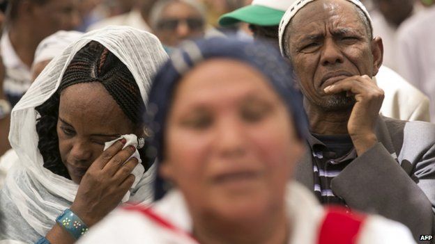 An Israeli of Ethiopian descent cries during a ceremony in Jerusalem commemorating Ethiopians that died during their immigration to Israel