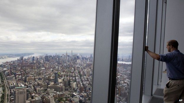 A visitor to One World Observatory looks over Manhattan, Wednesday, May 20, 2015, in New York