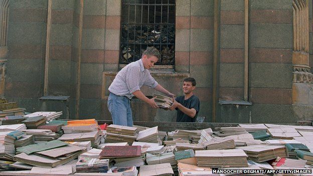 Sarajevo residents try to save some books from the basement of the National Library in Sarajevo on August 29, 1992.