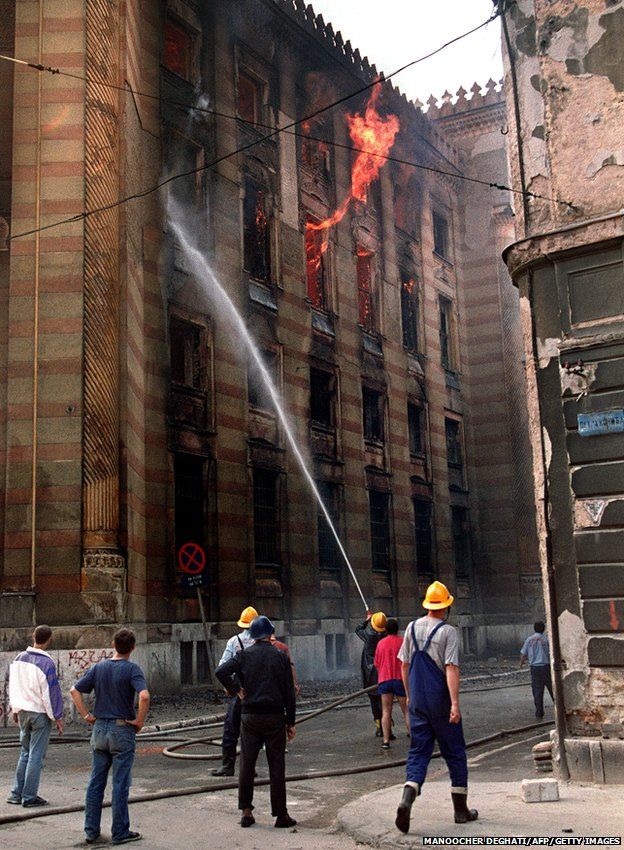 Firefighters douse flames inside the National Library in Sarajevo 26 August 1992
