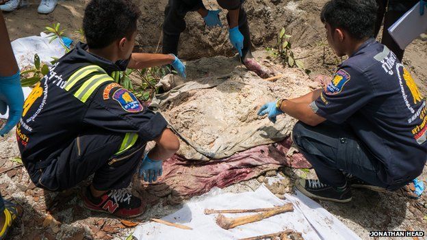Volunteers help exhume migrant graves, recovering bones from the forest ground
