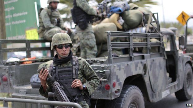Mexican soldiers stand guard at the entrance to Chilapa, Guerrero State, Mexico on May 10, 2015.