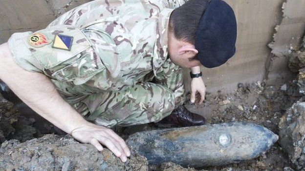 A bomb disposal expert inspects the 50kg device