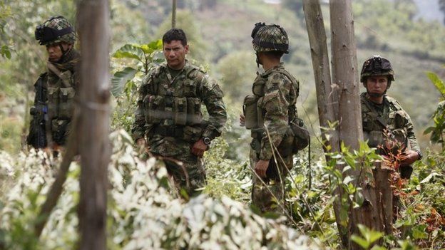 Colombian Army soldiers guard the area where an alleged FARC guerrilla attack on 14 April left 11 people dead, in Timba, Colombia, 15 April 2015.