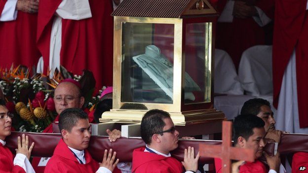 Priests carry the shirt Romero was wearing on the day he was killed