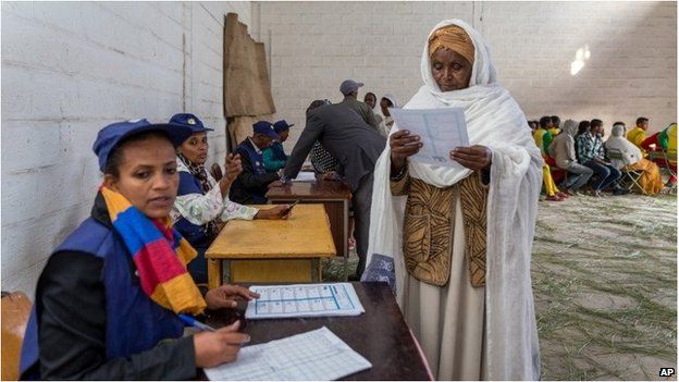 A woman looks at the election paper before voting in Addis Ababa.