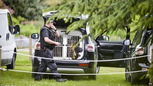 Police officer and police dog van inside the Oxford University Parks,