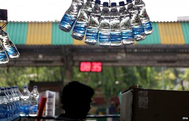 An Indian vendor sells drinking water at a railway platform while the temperatures reached 40 degree Celsius in Calcutta