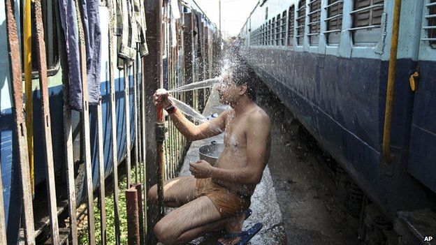 Train passenger cools off at railway station in Jammu. 25 May 2015