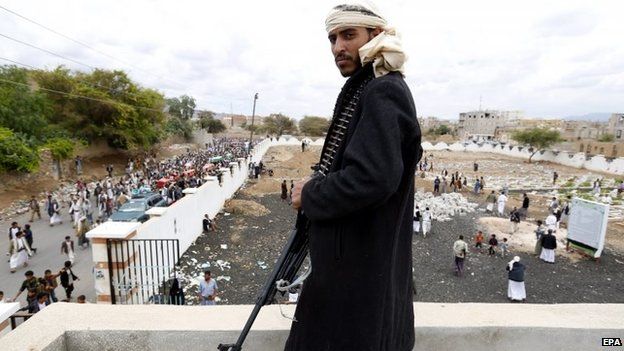 Houthi rebel looks at the burials of comrades killed in Saudi-led coalition air strikes in Sanaa, Yemen (24 May 2015)