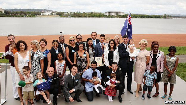 New Australian citizens pose with Prime Minister Tony Abbott in Canberra