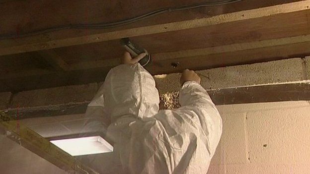 Worker clearing asbestos