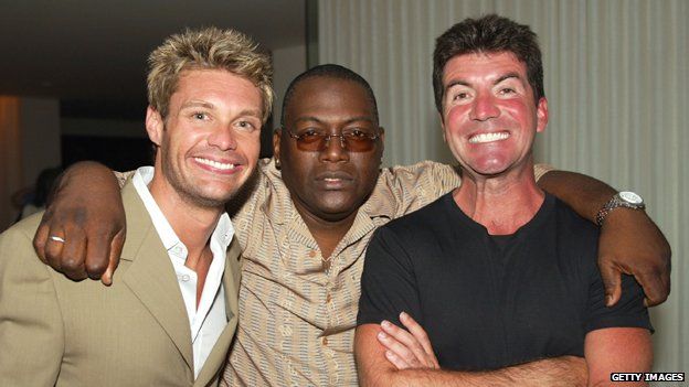 Ryan Seacrest and Simon Cowell showing off their white teeth