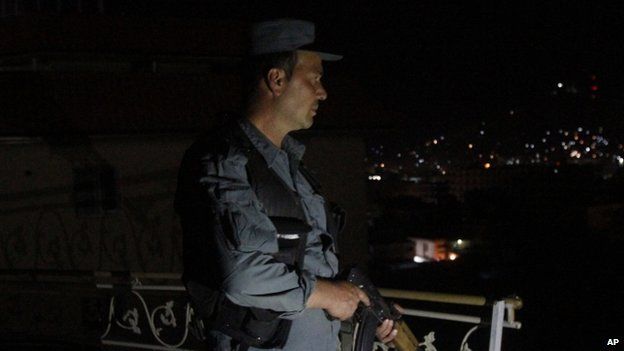 An Afghan security officer takes a position at a house near the attack on a guesthouse in Kabul (27 May 2015)