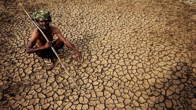 A farmer sits in his dried up land in gauribidanur village, doddaballapur district, close to Karnataka and Andhra Pradesh border on 26 May 2015