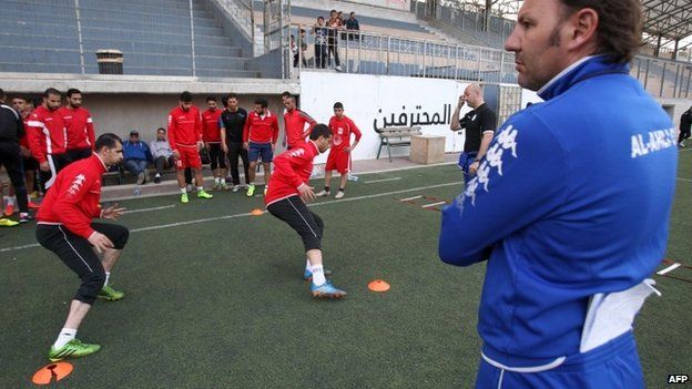 Ahli Al-Khalil's coach, Stefano Cusin, looks at his players during a training session on 24 April 2015 in the West Bank town of Hebron