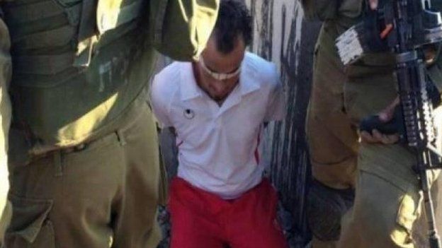 A photograph purportedly showing Palestinian football referee Farouq Assi blindfolded, handcuffed and in custody at an Israeli checkpoint in the West Bank