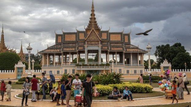 A group of Cambodian street vendors sells goods to tourists and local people in front of the Royal Palace