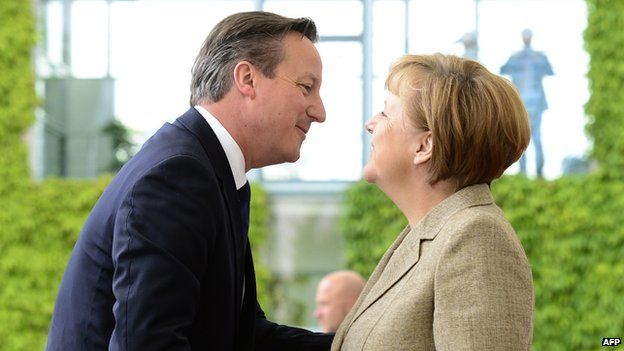 David Cameron and Angela Merkel greet each other in Berlin