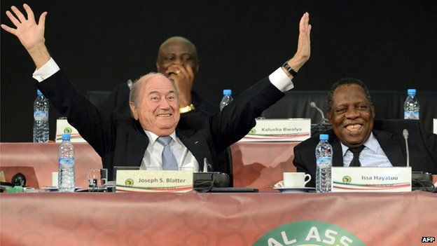 FIFA's president Sepp Blatter (L) gestures as he shares a joke with the public during a general assembly meeting after Cameroonian Issa Hayatou (R) was re-elected unopposed as president of the Confederation of African Football (CAF) on March 10, 2013, in Marrakesh.