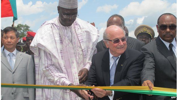 FIFA President Sepp Blatter (2nd R) and Cameroon's Sports Minister Adoum Garoua (2nd L) cut the ribbon during the inauguration of a CAF sports complex including three football stadiums in Mbankomo, Cameroon, on May 5, 2014