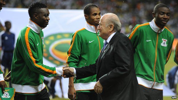 FIFA President Sepp Blatter shakes hands with Zambian players at the Africa Cup of Nations in Libreville, Gabon on February 12, 2012
