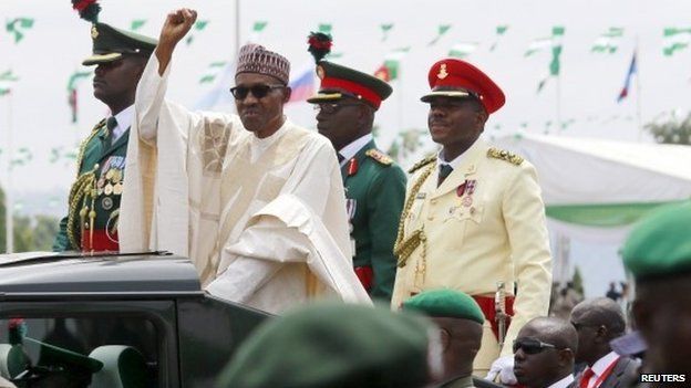 Nigeria"s new President Muhammadu Buhari rides in a motorcade while inspecting the guard of honour at Eagle Square in Abuja