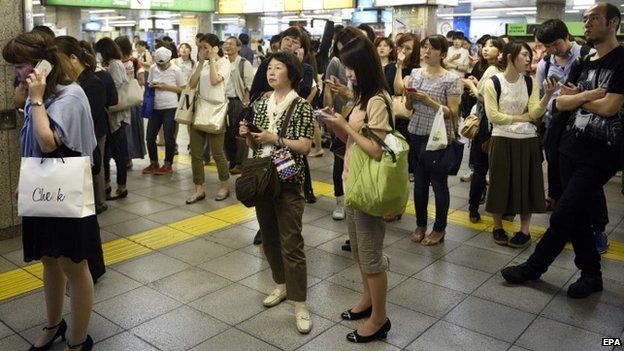 Commuters are stranded at Ikebukuro station as railway service is disrupted after a strong earthquake hit Tokyo area, Japan, 30 May 2015