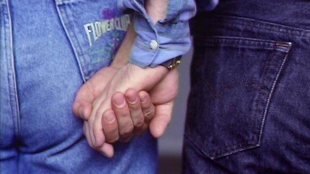 Two men holding hands