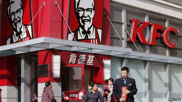 People walk past a KFC restaurant in Beijing, in this file photo taken October 23, 2013.