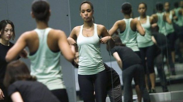 Miss Universe Japan Ariana Miyamoto is reflected on mirrors as she works out at a gym in Tokyo April 1, 2015