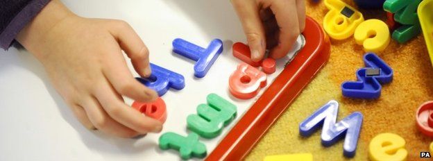 Child playing with magnetic letters
