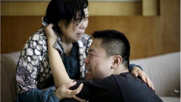Family members of passengers on the ship which sank at the Jianli section of Yangtze River, in Hubei province, cry outside a closed office of Xiehe Travel in Shanghai, China, 2 June 2015